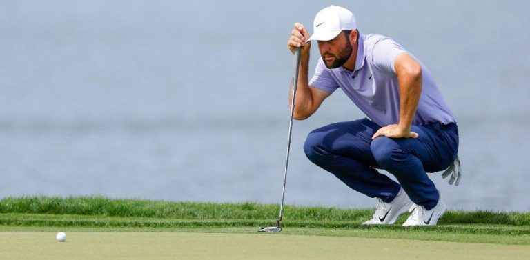 Scottie Scheffler concentrating on a putt during a golf tournament