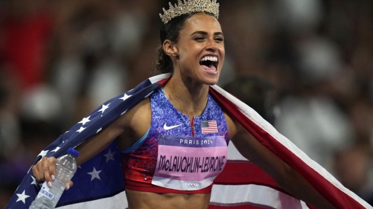 Sydney McLaughlin-Levrone celebrates after achieving an Olympic goal in track and field.