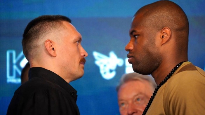 Oleksandr Usyk and Daniel Dubois face off in the ring.